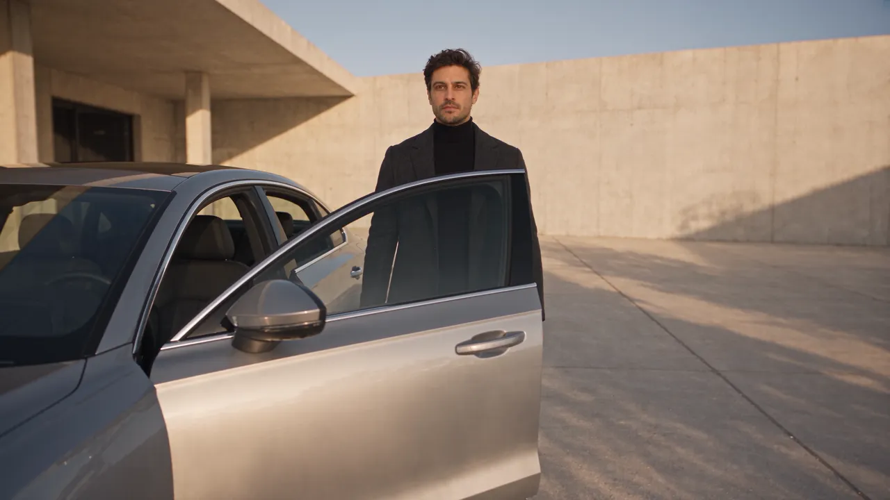 The finished shot of the man getting into a silver sedan